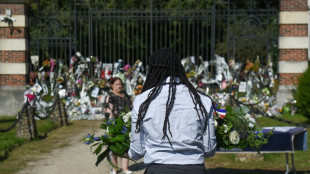 Film legend Delon is buried near his dogs as fans mourn